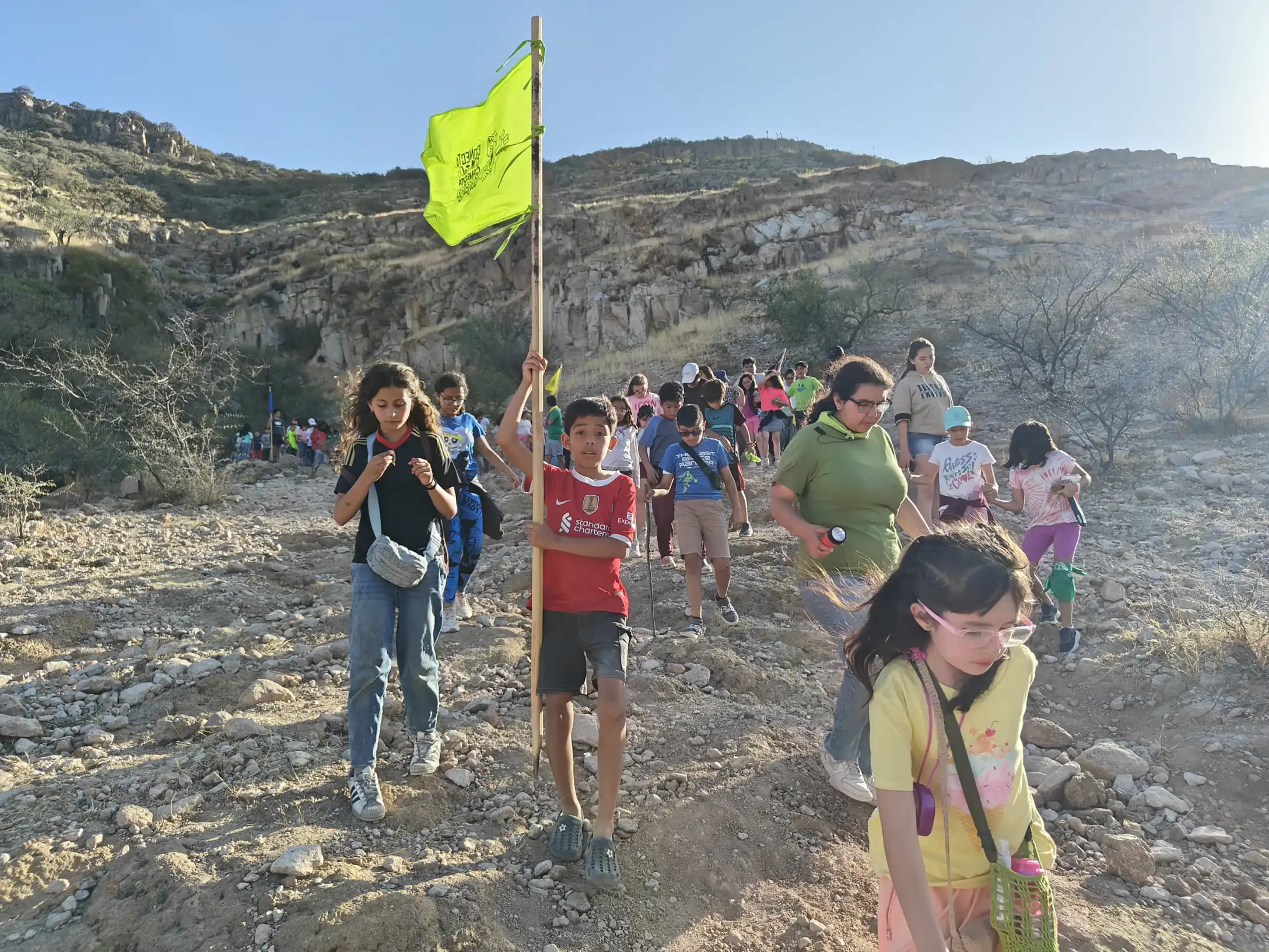 Caminata en la montaña con la bandera del grupo