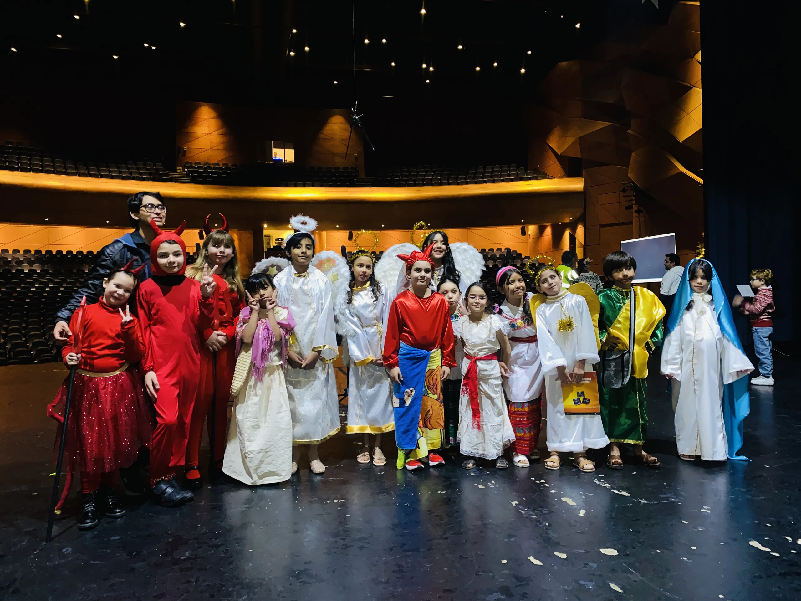 Elenco infantil de teatro con vestuario, al final de la función
